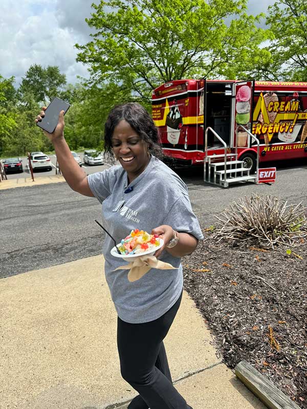Woman Smiling with Her Ice Cream Sundae