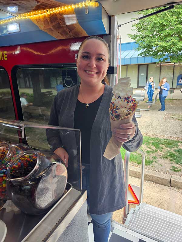 Woman Holding Huge Ice Cream in a Waffle Cone