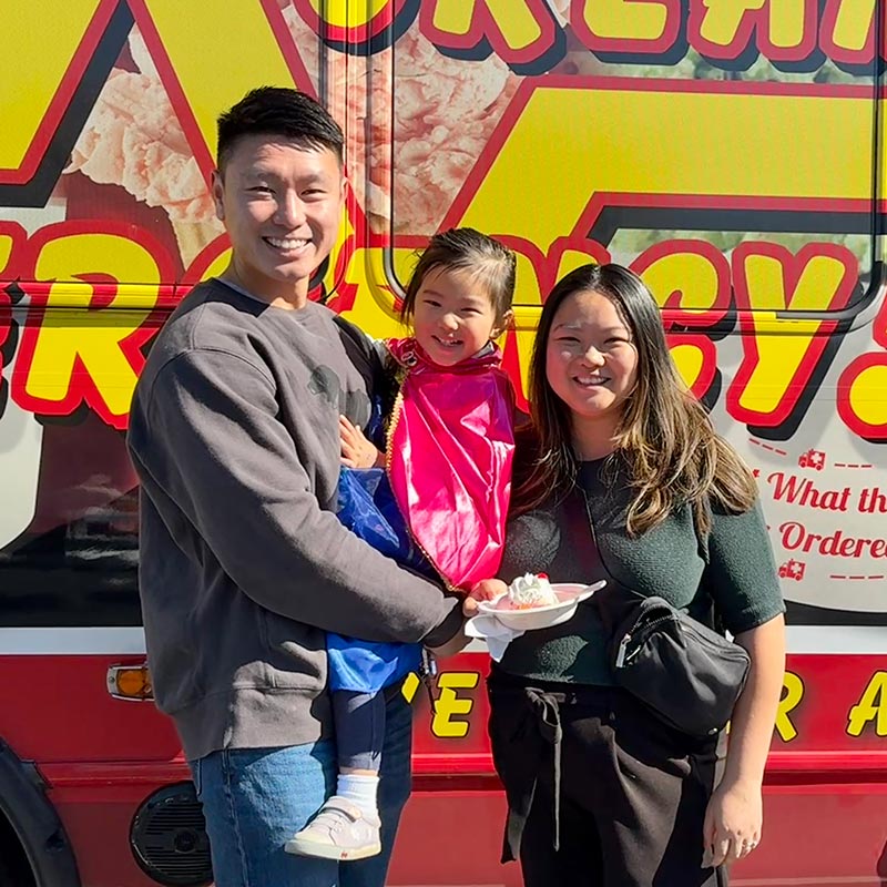 Family Standing in Front of the ICE Bus with Their Ice Cream
