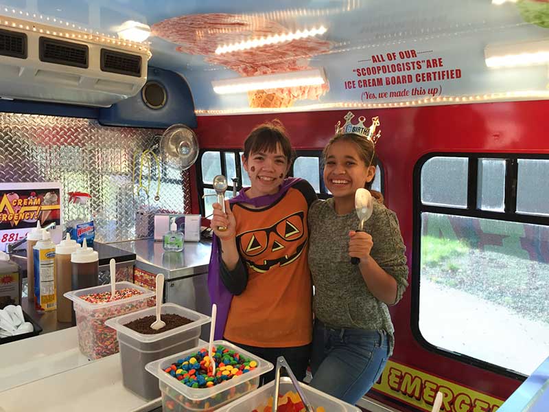Kids Holding Up Ice Cream Scoopers Kids Holding Up Ice Cream Scoopers