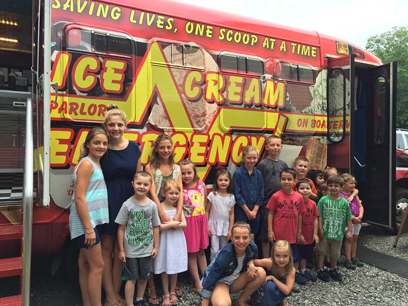 Young Kids in Front of the Ice Cream Emergency Truck Young Kids in Front of the Ice Cream Emergency Truck
