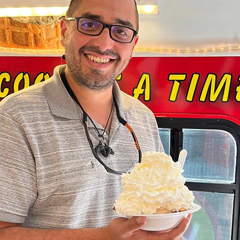 Man Holding Ice Cream with Whipped Cream Man Holding Ice Cream with Whipped Cream