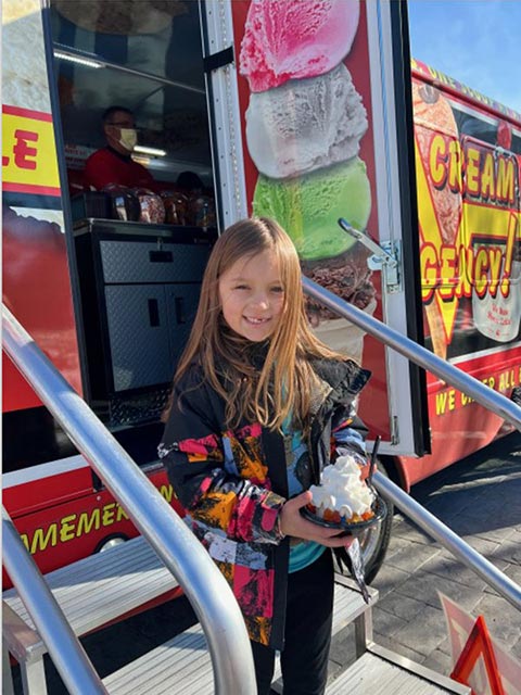 Girl Holding Sweet Treat From the Southern Rhode Island Ice Cream Emergency Bus Girl Holding Sweet Treat From the Southern Rhode Island Ice Cream Emergency Bus