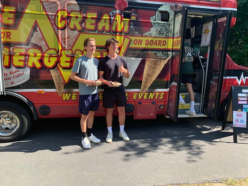 Standing in Front of ICE Bus Eating Ice Cream